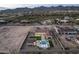 Aerial view of a luxury home with a pool and landscaped grounds, located in a mountain setting at 12331 E Gold Dust Ave, Scottsdale, AZ 85259