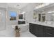 Elegant bathroom with double vanities, a large soaking tub, and marble floors at 12331 E Gold Dust Ave, Scottsdale, AZ 85259