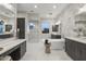 Modern bathroom with double vanities, a large soaking tub, and marble floors at 12331 E Gold Dust Ave, Scottsdale, AZ 85259