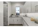 Bright butler's pantry with a farmhouse sink and window view at 12331 E Gold Dust Ave, Scottsdale, AZ 85259