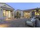 Evening view of a charming courtyard with seating area and brick pavers at 12331 E Gold Dust Ave, Scottsdale, AZ 85259