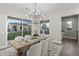 Spacious dining room with a chandelier, wooden table, and views of the backyard at 12331 E Gold Dust Ave, Scottsdale, AZ 85259