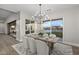 Elegant dining room features a chandelier, hardwood floors, and sliding glass doors to patio at 12331 E Gold Dust Ave, Scottsdale, AZ 85259