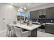 Modern kitchen with dark cabinetry, a large island, and stainless steel appliances at 12331 E Gold Dust Ave, Scottsdale, AZ 85259