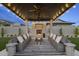 Covered patio with fireplace and seating area, perfect for outdoor entertaining at 12347 E Gold Dust Ave, Scottsdale, AZ 85259