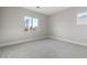 Spacious bedroom with neutral carpeting and large window at 12347 E Gold Dust Ave, Scottsdale, AZ 85259