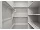 Spacious walk-in closet with custom shelving and hanging rods at 12347 E Gold Dust Ave, Scottsdale, AZ 85259