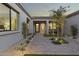 Inviting courtyard with artificial turf, brick pavers, and desert plants creates a tranquil setting at 12347 E Gold Dust Ave, Scottsdale, AZ 85259