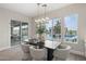 Elegant dining area with large windows overlooking the pool and backyard at 12347 E Gold Dust Ave, Scottsdale, AZ 85259