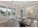 Spacious dining area with large windows and a modern chandelier at 12347 E Gold Dust Ave, Scottsdale, AZ 85259