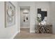 Bright and airy entryway features unique wood console table and artwork at 12347 E Gold Dust Ave, Scottsdale, AZ 85259