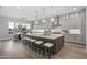 Gourmet kitchen featuring a large island, pendant lighting, and white cabinets at 12347 E Gold Dust Ave, Scottsdale, AZ 85259