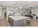 Modern kitchen with white cabinetry, large island, and breakfast bar at 12347 E Gold Dust Ave, Scottsdale, AZ 85259