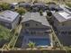 Aerial view of house with pool and solar panels at 1240 W Falls Canyon Dr, Casa Grande, AZ 85122