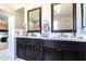 Elegant bathroom with double vanity, large mirrors, and marble tile at 1240 W Falls Canyon Dr, Casa Grande, AZ 85122