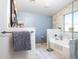 Elegant bathroom with marble tile and a relaxing bathtub at 1240 W Falls Canyon Dr, Casa Grande, AZ 85122