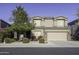 Two-story house with tan exterior, landscaped yard, and two-car garage at 1240 W Falls Canyon Dr, Casa Grande, AZ 85122