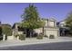 Two-story house with stone accents and a landscaped front yard at 1240 W Falls Canyon Dr, Casa Grande, AZ 85122