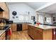 Kitchen with island, wood cabinets, and red wall at 1240 W Falls Canyon Dr, Casa Grande, AZ 85122