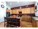 Kitchen with island, wood cabinets, and red wall at 1240 W Falls Canyon Dr, Casa Grande, AZ 85122