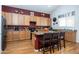 Kitchen with island, wood cabinets, and red wall at 1240 W Falls Canyon Dr, Casa Grande, AZ 85122