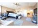 Main bedroom with large bed, sitting area, and ensuite bathroom access at 1240 W Falls Canyon Dr, Casa Grande, AZ 85122