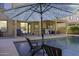 Pool area with patio furniture under an umbrella at 1240 W Falls Canyon Dr, Casa Grande, AZ 85122