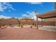 Full backyard view featuring a cozy pergola and a landscaped fire pit area at 12474 W Redfield Rd, El Mirage, AZ 85335