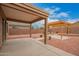 Backyard featuring a patio and a pergola over a gravel base with desert landscaping at 12474 W Redfield Rd, El Mirage, AZ 85335