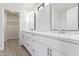 Bathroom featuring a dual sink vanity with quartz countertops, a modern faucet, and bright lighting at 12474 W Redfield Rd, El Mirage, AZ 85335