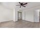 Bedroom featuring a ceiling fan, new hardwood floors, and multiple doorways for convenient access at 12474 W Redfield Rd, El Mirage, AZ 85335