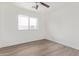 Bright bedroom with modern ceiling fan and light wood flooring at 12474 W Redfield Rd, El Mirage, AZ 85335