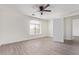 Bedroom featuring a ceiling fan, new hardwood floors, a large window, and an open doorway at 12474 W Redfield Rd, El Mirage, AZ 85335