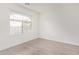 Bright bedroom with light wood flooring and a window at 12474 W Redfield Rd, El Mirage, AZ 85335