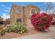 Charming home featuring a neutral color palette, tile roof, an attached two-car garage, bougainvillea and cactus at 12474 W Redfield Rd, El Mirage, AZ 85335