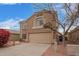 Inviting home features neutral palette, tile roof, an attached two-car garage, xeriscaping and mature shade tree at 12474 W Redfield Rd, El Mirage, AZ 85335