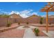 Stone-lined fire pit surrounded by desert landscaping, offering a backyard retreat at 12474 W Redfield Rd, El Mirage, AZ 85335