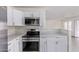 A modern kitchen featuring quartz countertops, white cabinets, and stainless steel appliances at 12474 W Redfield Rd, El Mirage, AZ 85335