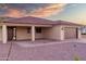 Single-story home featuring a terracotta roof, desert landscaping, and brick accents, complemented by a brown garage door at 125 Ironwood Pl, Wickenburg, AZ 85390