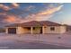 Beautiful single-story home boasts a symmetrical facade, neutral color palette, desert landscaping, and a terracotta tile roof at 125 Ironwood Pl, Wickenburg, AZ 85390