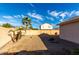 Sunny backyard with gravel, stone pathway, and palm trees at 12962 W Catalina Dr, Avondale, AZ 85392