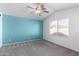 Bright bedroom with ceiling fan, carpet, and large window at 12962 W Catalina Dr, Avondale, AZ 85392