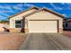 One-story house with light beige exterior, a two-car garage, and rock landscaping at 12962 W Catalina Dr, Avondale, AZ 85392