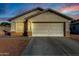 One-story house with light beige exterior, a two-car garage, and rock landscaping at 12962 W Catalina Dr, Avondale, AZ 85392