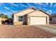 One-story house with light beige exterior, a two-car garage, and rock landscaping at 12962 W Catalina Dr, Avondale, AZ 85392