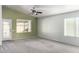 Spacious living room with neutral wall color, carpet flooring, and a ceiling fan at 12962 W Catalina Dr, Avondale, AZ 85392