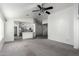 Living room with an open floor plan, carpet flooring, and a view of the kitchen at 12962 W Catalina Dr, Avondale, AZ 85392