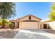 Single-story house with a two-car garage and desert landscaping at 13353 W Port Royale Ln, Surprise, AZ 85379