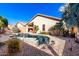 Inviting backyard oasis featuring a sparkling pool and relaxing patio at 13353 W Port Royale Ln, Surprise, AZ 85379