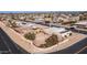 Aerial view of a single-story home with a large backyard and a unique patio design at 14202 N Lakeforest Dr, Sun City, AZ 85351